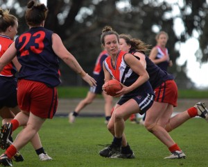 Falcons' star Daisy Pearce sizes up her options in a sea of opponents (Photo: Rusty's Pix)