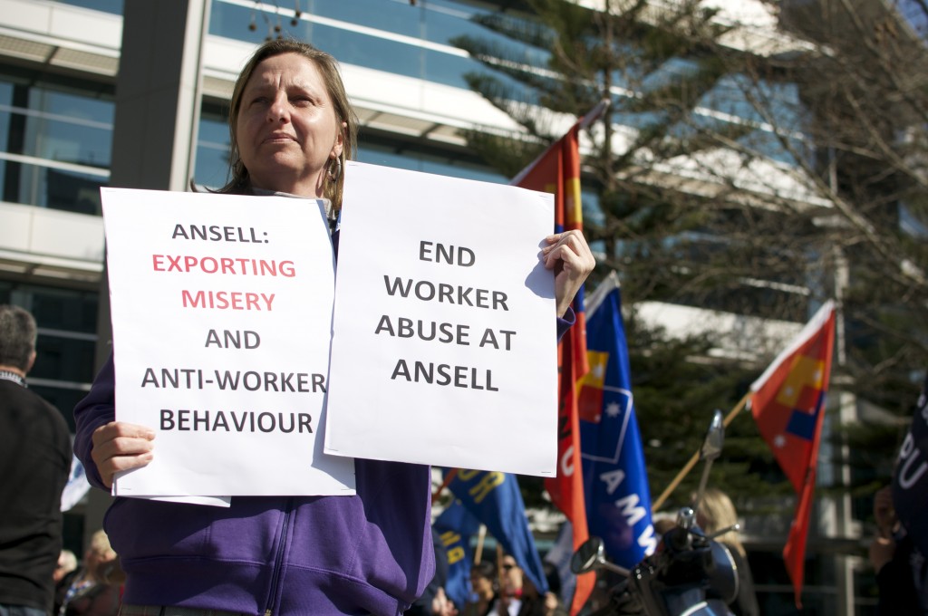 A protestor outside Ansell HQ in Richmond, rally for Sri Lankan trade unionists to be allowed to visit Australia for talks with the manufacturing corporation