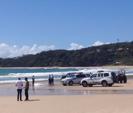 Police recover the body of a man attacked by a shark at Byron Bay, NSW. Photo: Lochie Alvin