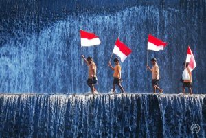 kids-with-indonesian-flags-crossing-a-waterfall-happy-independence-day-of-indonesia