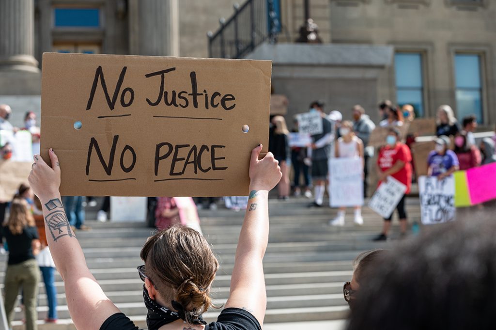 BLM protest sign saying no justice no peace