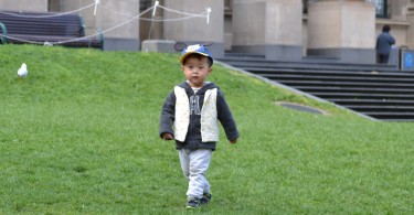Boy playing on the Victorian State Library lawn