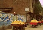 Fruit vendors in the city of Peshawar who appear to be selling a variety of melons