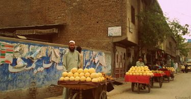 Fruit vendors in the city of Peshawar who appear to be selling a variety of melons