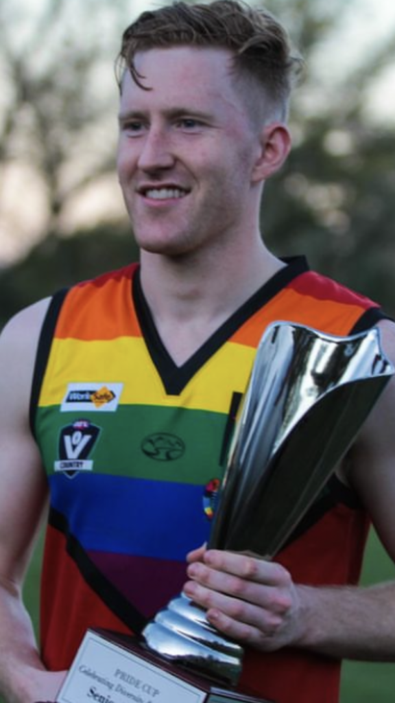 Jason Ball holding the pride cup
